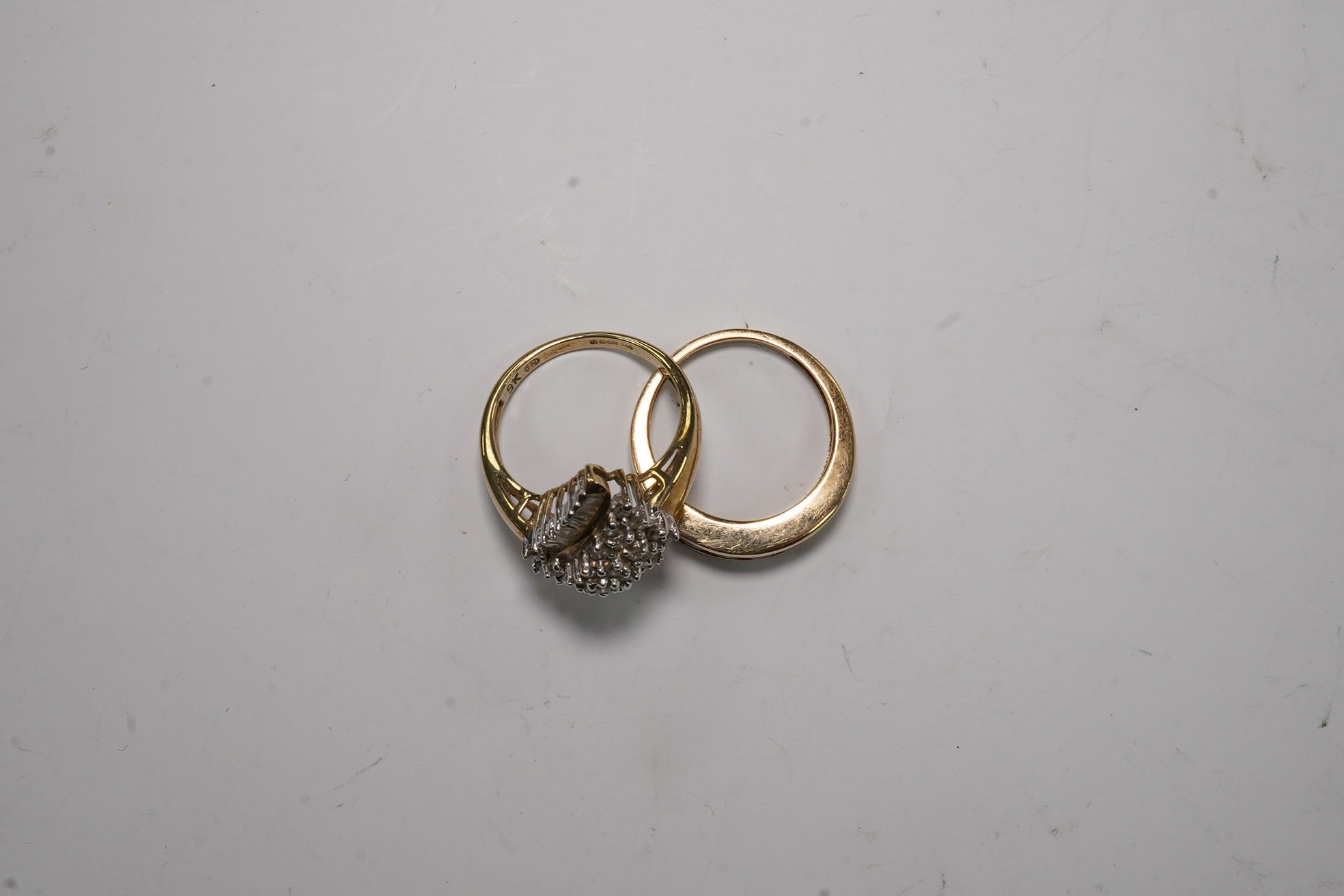 Two modern 9ct gold and diamond set rings, diamond chip cluster and five stone coloured diamond set half hoop, both size L, gross weight 6.4 grams. Condition - poor to fair